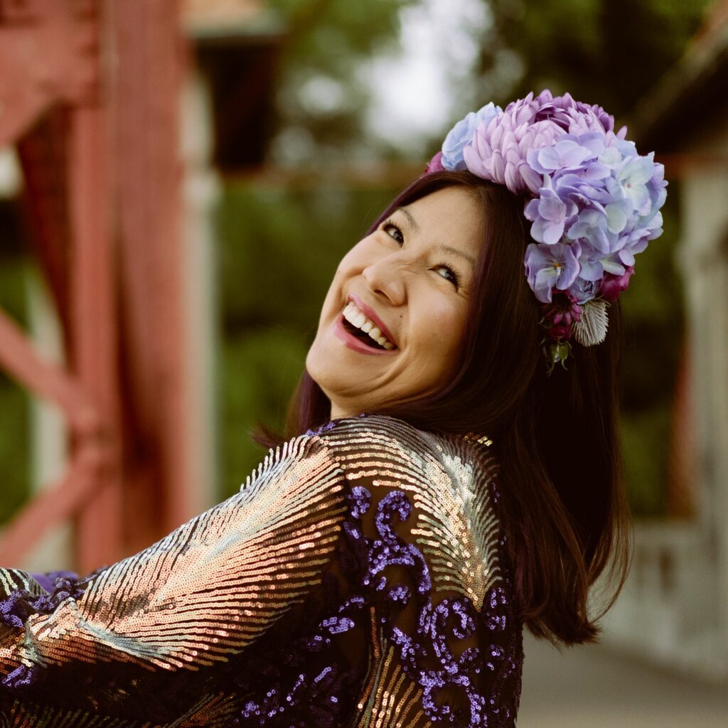Laughing creator sparkly robe headshot lighter Jenn M. Choi